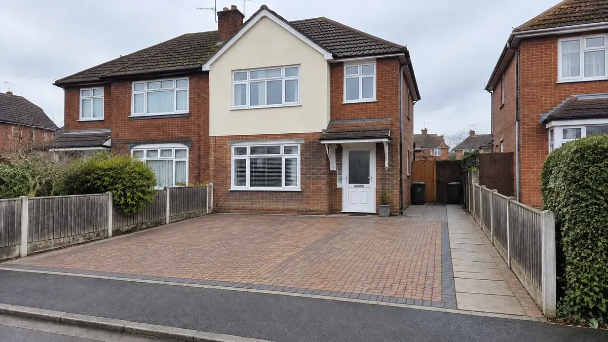 Clean block-paved driveway and path at a red-brick Essex family home